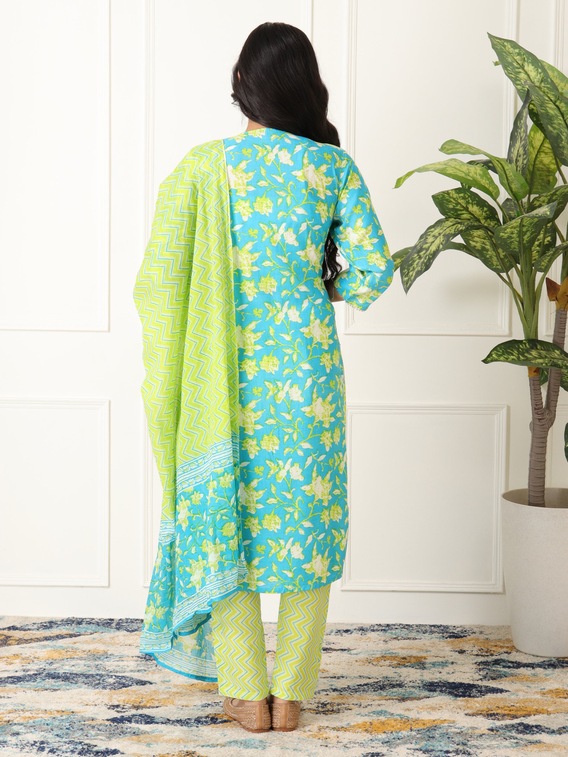 Woman wearing a blue and green floral outfit kurti set for women under Rs. 999